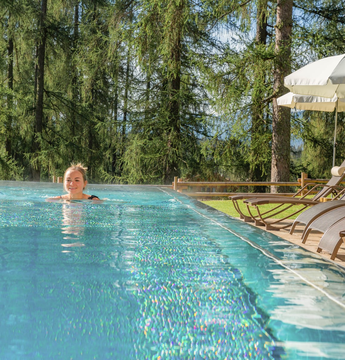 Woman swimming in the pool at Hotel Lindenhof
