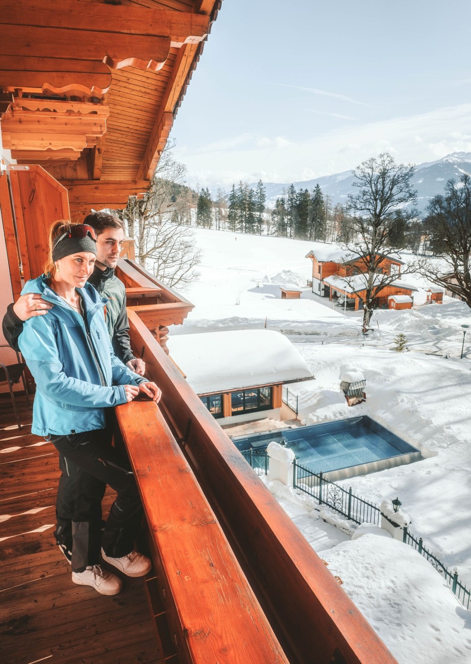 Paar genießt die klare Winterluft auf dem Balkon 
