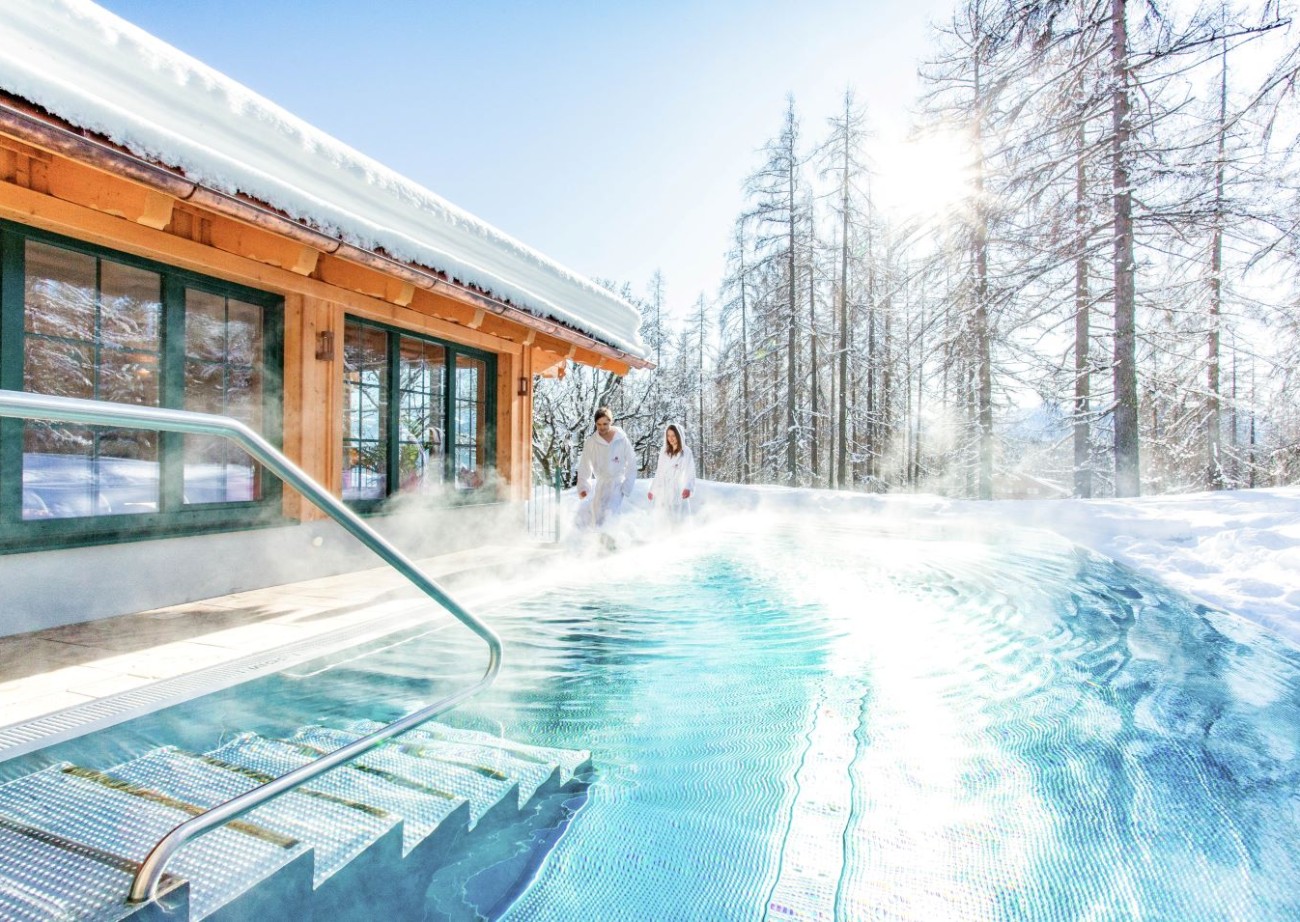 Woman swimming in the infinity pool at Hotel Lindenhof
