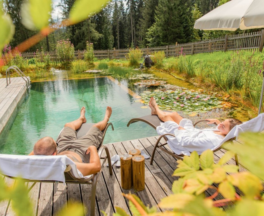 Woman swimming in the infinity pool at Hotel Lindenhof