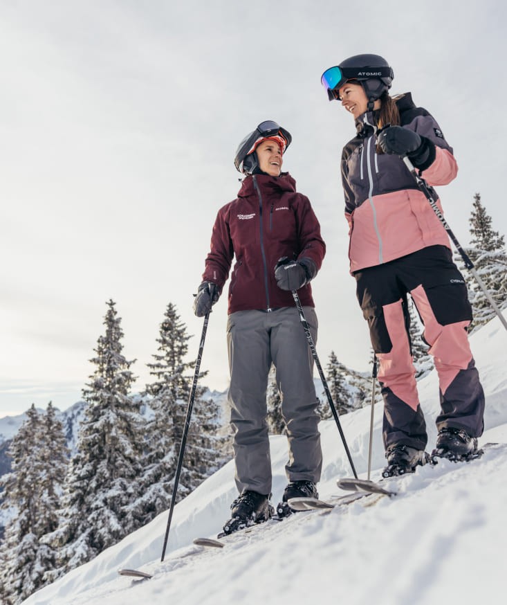 Skiers on a slope with a breathtaking mountain backdrop in Schladming; Gerald Gruenwald